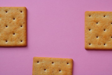 on a pink background three crackers on the sides