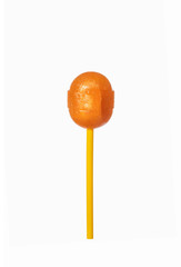 Orange lollipop isolated over a white background