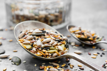 Healthy seeds mix in a wooden spoon close up. Healthy foods, vegan food ingredient.