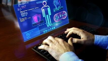 Man typing on the keyboard with create and code new game on hologram screen on desk. Cyber video gaming, digital esport and computer play programming concept. Hand shake camera. - Powered by Adobe