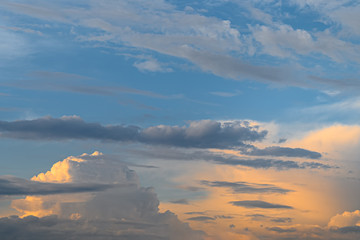 Fototapeta na wymiar Blue, yellow and orange sunset with clouds