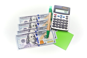 American dollars, pen, note paper and calculator on white background.