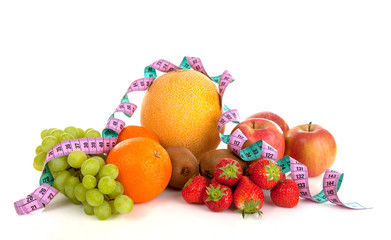 Diet scenery with fresh fruit en measuring tape over white background