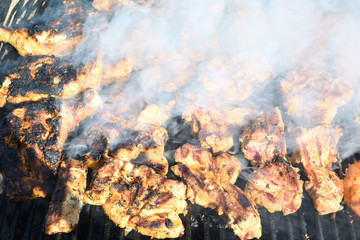 Meat on the grill. Chef cooking grilling mix of fresh grilled chicken meat