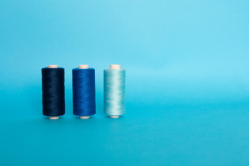 Blue and gray threads on blue background