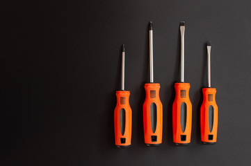 Orange screwdrivers in black background
