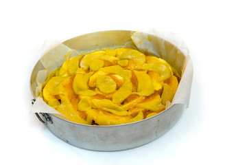 Crostata cake made with apple and apricot jam in a round baking pan