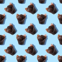 Seamless pattern of chocolate muffin with light blue background. Sweetness pastel colors. Confectionery banner. Colorful.