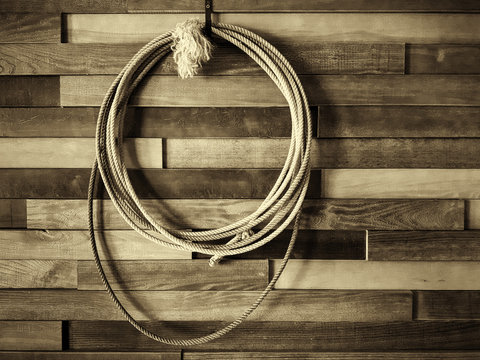Wild West style restaurant and cowboy. On the wall is a shepherd's lasso. Picture taken in Ukraine, Kiev region. Horizontal frame. Black and white image. Sepia.