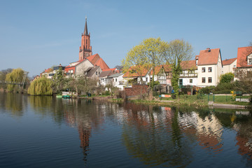 Fototapeta na wymiar St. Marien-Andreas church at the city canal at the old harbour in Rathenow 