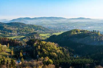 Fototapeta na wymiar beautiful valley with village and fog in spring morning, Beskydy mountains