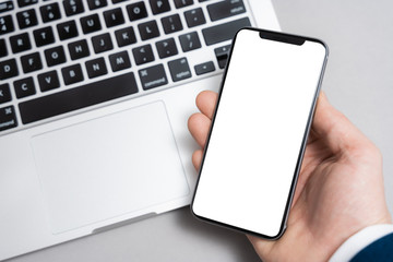 Smartphone mockup. Hand holding black mobile phone with blank and white screen.