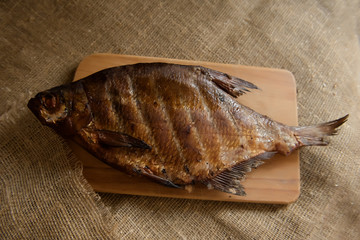 smoked fish on a wooden Board