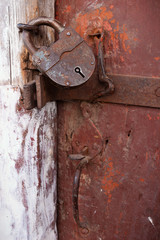 Summer day. Old farm. In the frame of an old padlock on the barn. Ukraine, Kharkiv region. Color image. Vertical frame.