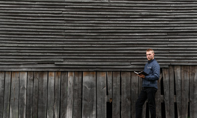 Fototapeta premium man standing on a wooden fence