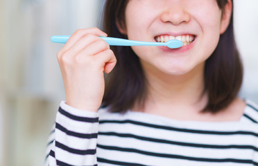 Japanese girl brushing tooth in the wash room