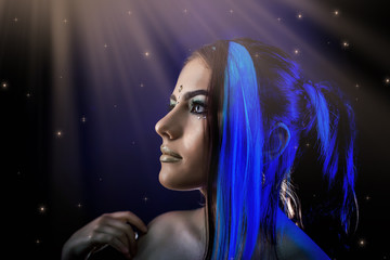 ethnic girl on a black background in blue light