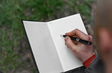 woman writing on a notebook