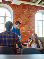 Young colleagues working in office together