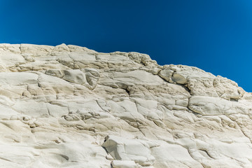 Fototapeta na wymiar Stair of the Turks (Scala dei Turchi) landscape, must see attraction and landmark of Sicily, Italy. Beautiful view of white, limestone, marl rock. Unique shape and surface with 