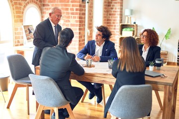 Group of business workers working together in a meeting. Listening one of them speaking at the office.