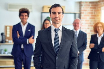 Group of business workers smiling happy and confident in a meeting. Standing with smile on face looking at camera at the office.