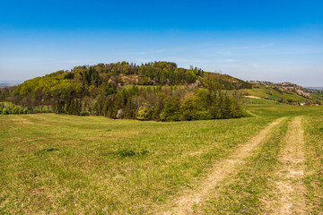 Obraz premium green fields and beautiful hills colored green and white in early spring