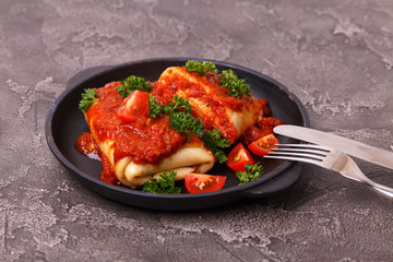 traditional Mexican cuisine chimichanga. Corn cake with minced meat, pepper, onion, garlic, oregano and marinara sauce