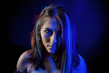 ethnic girl on a black background in blue light