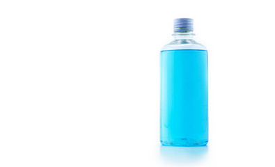 transparent blue alcohol in big bottle in white background