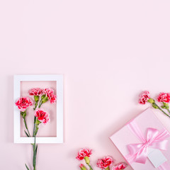 Mother's Day, Valentine's Day background design concept, beautiful pink, red carnation flower bouquet on pink table, top view, flat lay, copy space.