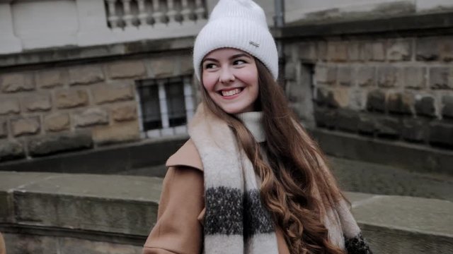 Happy girl smiling while walking on the street