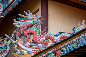 Colorful dragon sculpture on the roof In a Buddhist temple in Danang, Vietnam