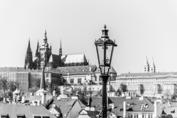 Vintage street lamp on Charles Bridge. Prague Castle out of focus on the background. Prague, Czech Republic