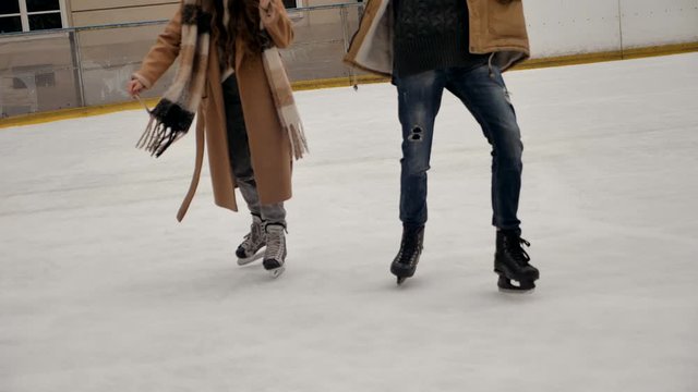Lovely couple skiing on the ski rink