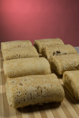 Raw rolled pancakes with filling ready to be roasted