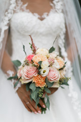 Wedding bouquet of bride that she holds in her hands