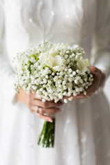 Wedding bouquet of bride that she holds in her hands