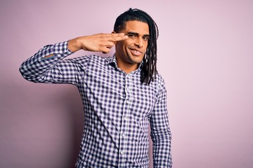 Fototapeta premium Young handsome african american afro man with dreadlocks wearing casual shirt Shooting and killing oneself pointing hand and fingers to head like gun, suicide gesture.