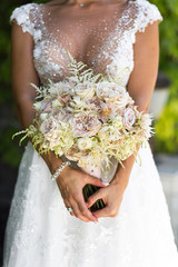 Wedding bouquet of bride that she holds in her hands