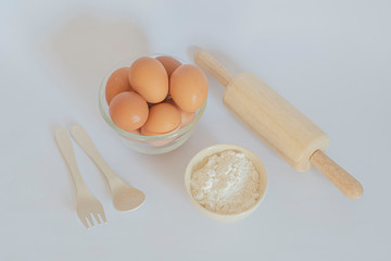 Eggs and corn flour on a white background