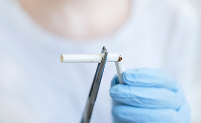 Broken cigarette, medical clip and gloves. Stop smoking, Quit smoking for health.Say no thanks to...