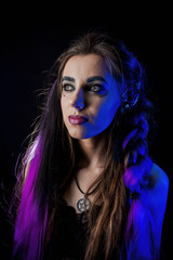 Girl in werewolf style on a black background with blue light