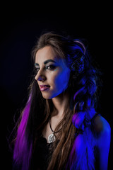 Girl in werewolf style on a black background with blue light