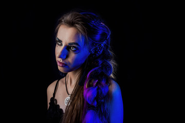 Girl in werewolf style on a black background with blue light