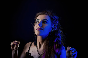 Girl in werewolf style on a black background with blue light