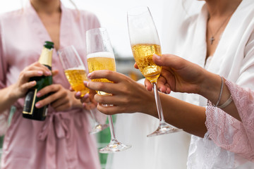 Bridesmaids drink champagne at the wedding day