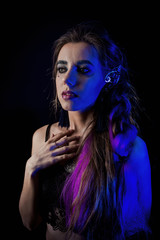 Girl in werewolf style on a black background with blue light