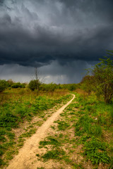 Dramatic view of a shelf cloud over a field, horizontal cloud formation, view.