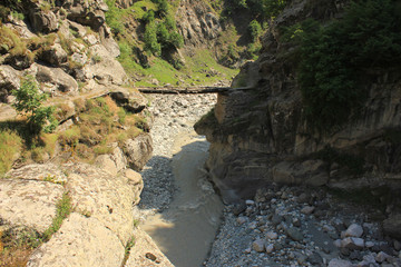 Decrepit wooden bridge over the river.